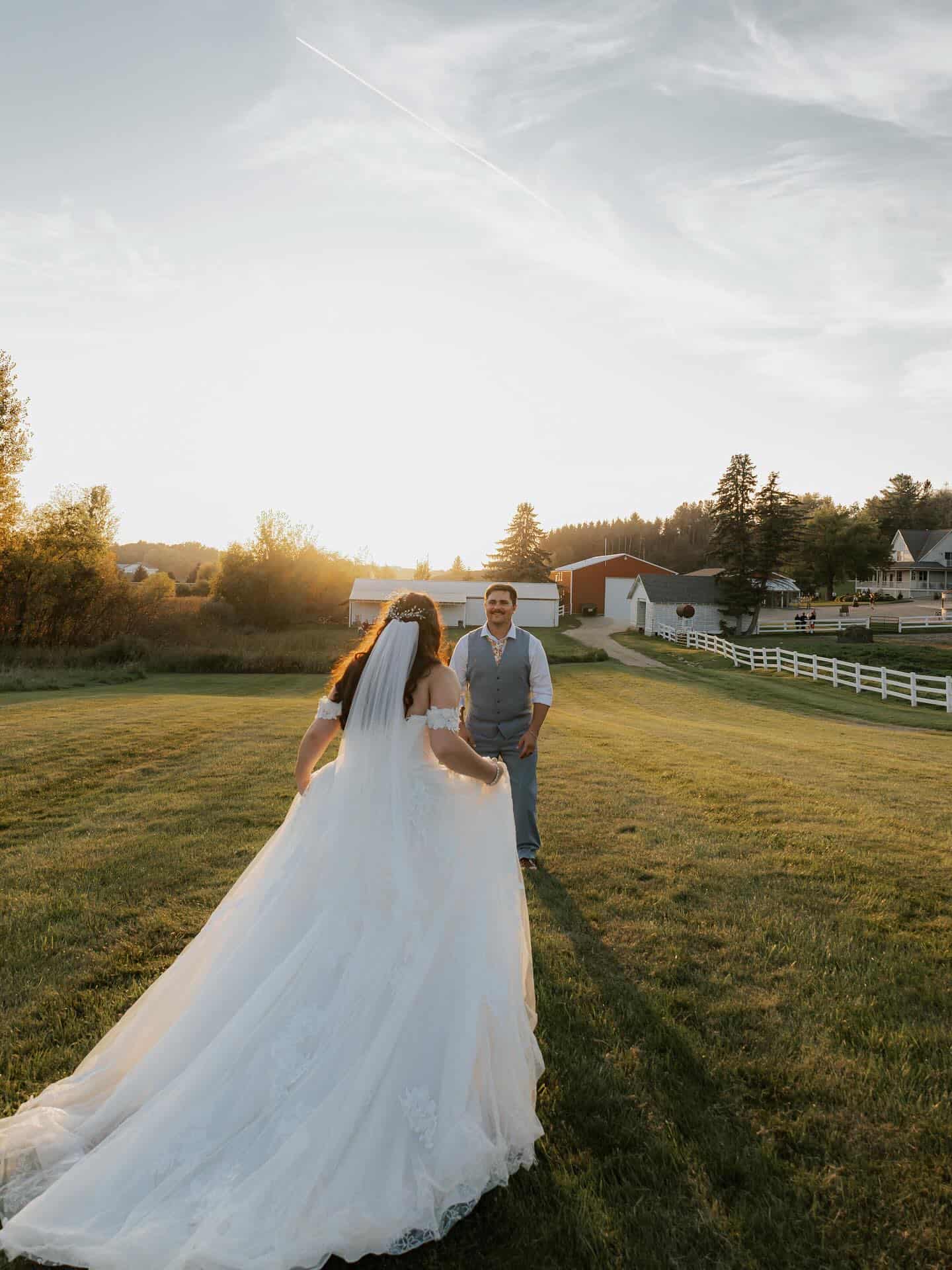 Wedding couple at Dellwood Barn wedding venue, outdoor ceremony with scenic countryside backdrop.