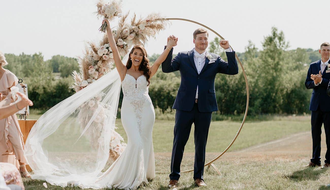 Wedding at Dellwood Barn with bride and groom celebrating outdoors.