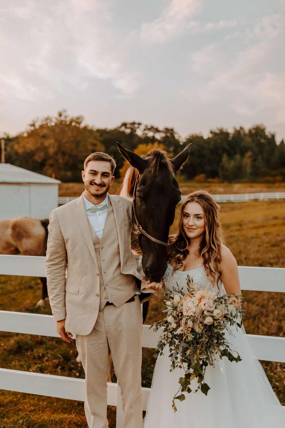Barn wedding couple with horse at Dellwood Barn, romantic outdoor wedding venue.