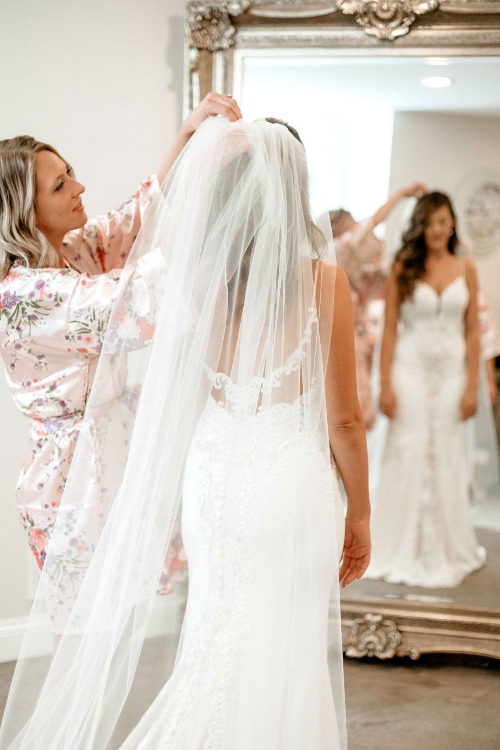Bride preparing with veil before her wedding ceremony at Dellwood Barn.
