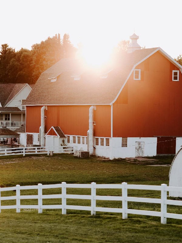 Beautiful red barn at Dellwood Barn Weddings with scenic countryside backdrop.