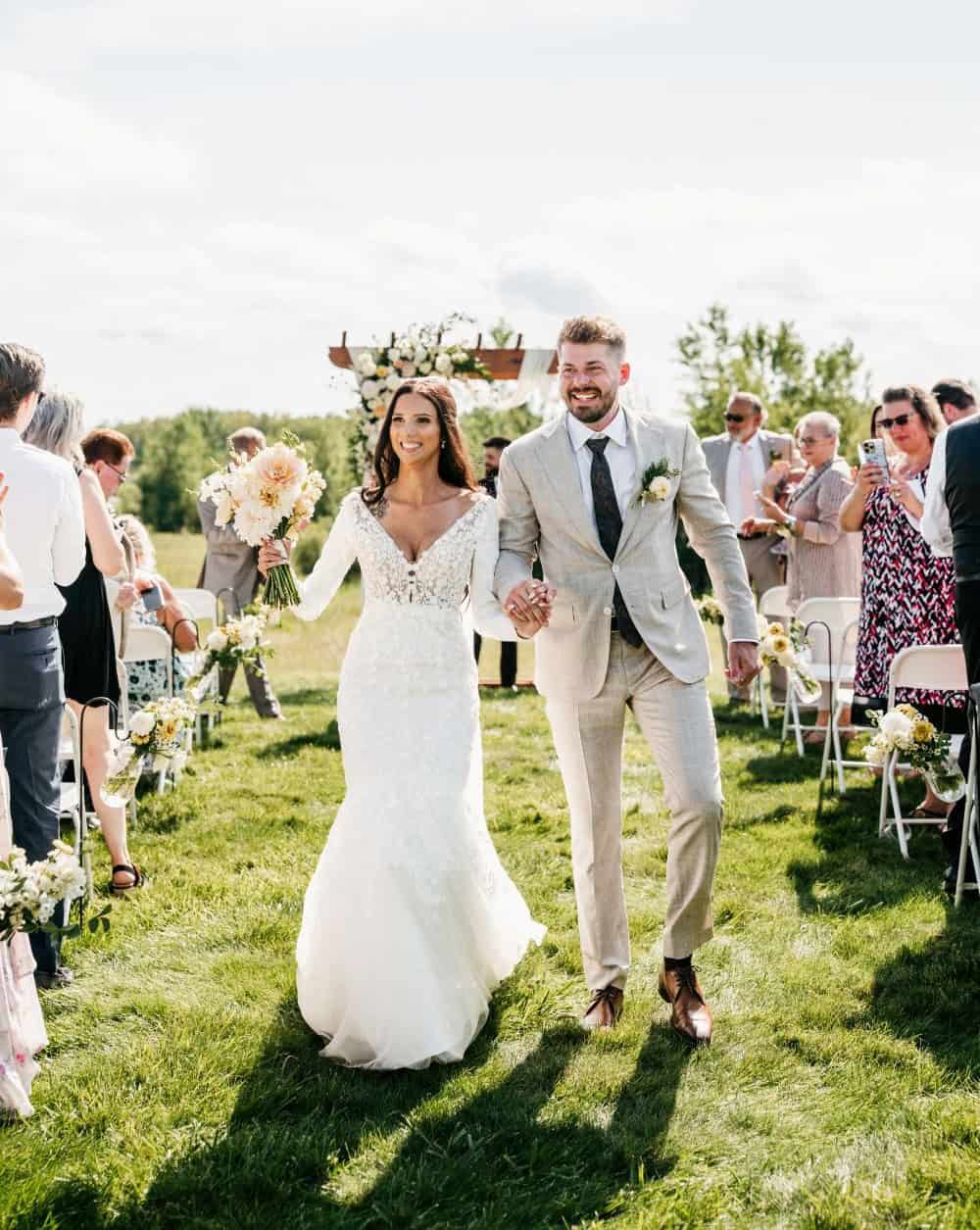 Wedding couple walking down the aisle at Dellwood Barn wedding venue.