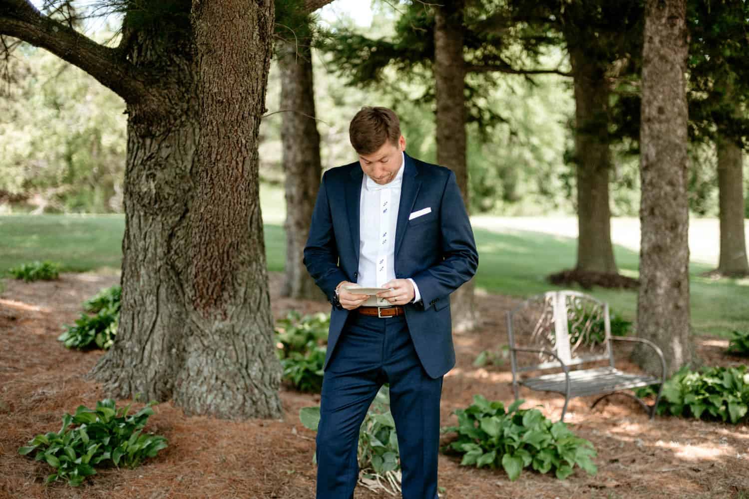 Wedding guest reading vows outdoors at Dellwood Barn.