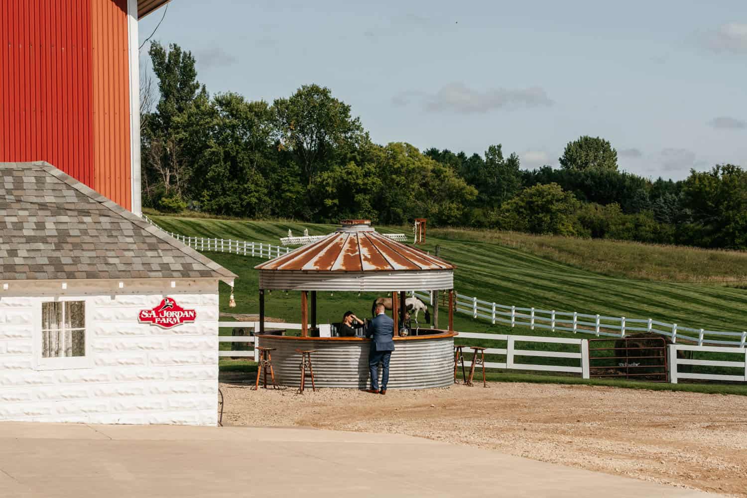 Outdoor barn wedding reception area with rustic charm and scenic countryside views.